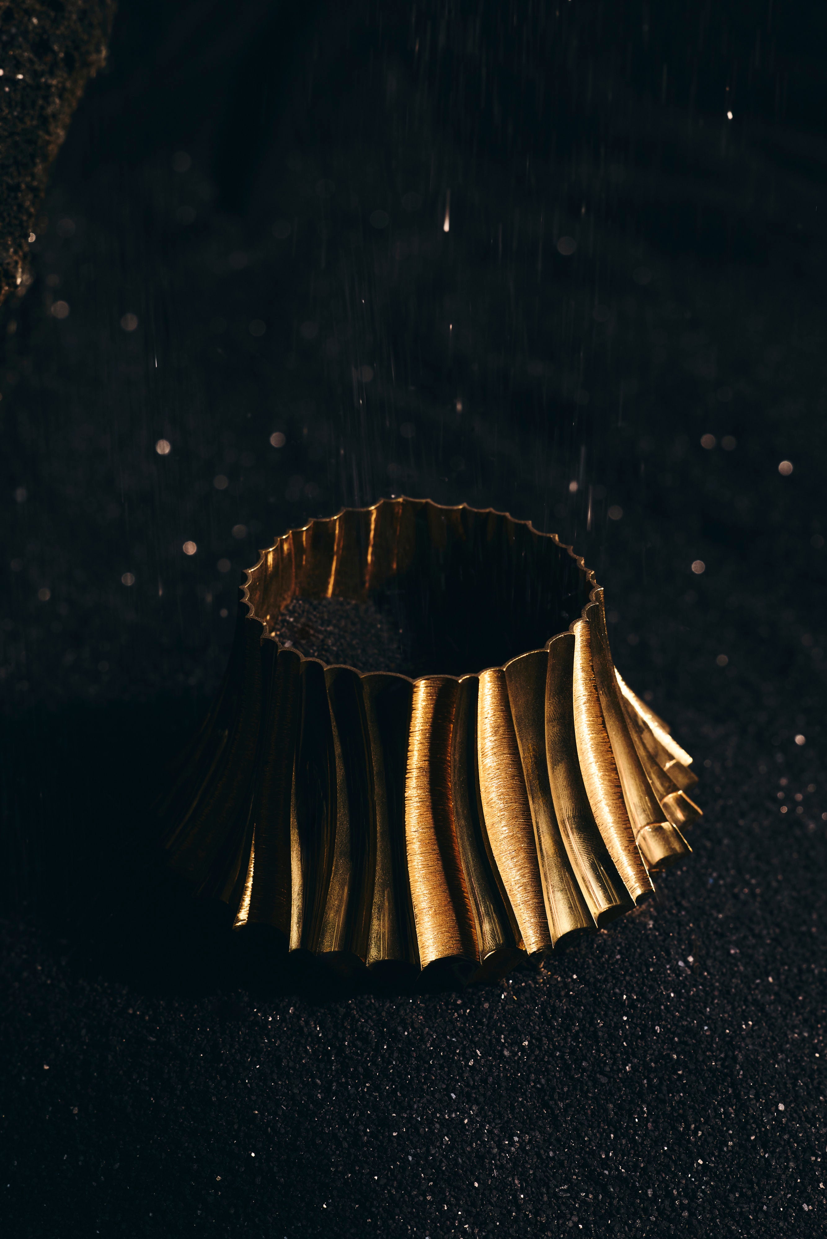 Coriolis Bangle sculpted in bronze with continuous circular textured form, finished in 24k gold plating